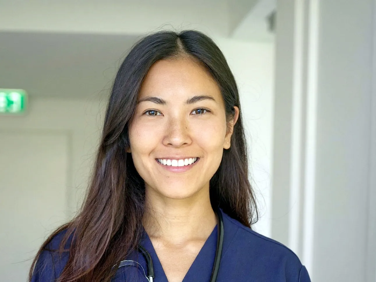 Filipina nurse in a hospital corridor
